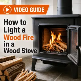 How to light a wood fire in a wood stove video guide with kindling burning inside an open wood stove